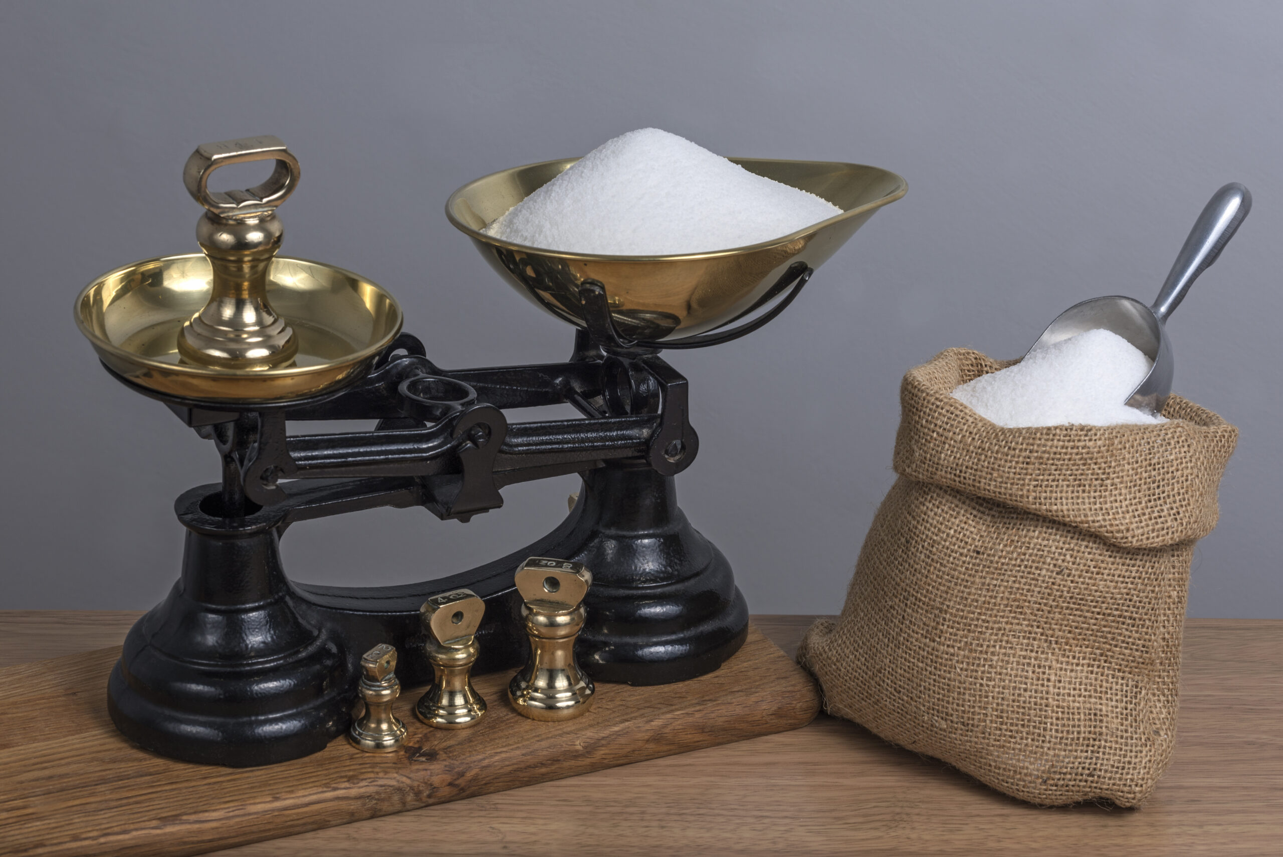 Using antique cast iron and brass scales to weigh sugar